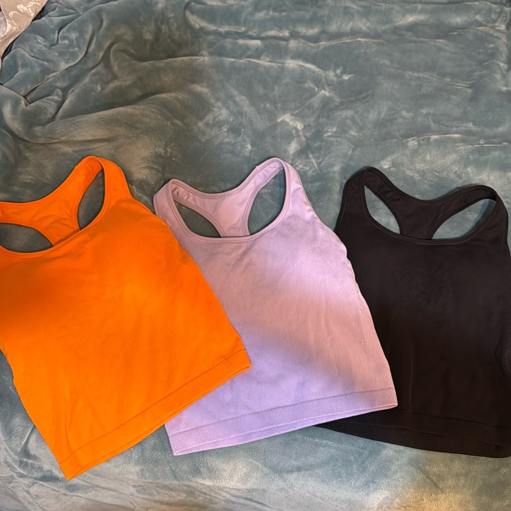 Sm/medium tanks with built in bras. They stop above the belly button